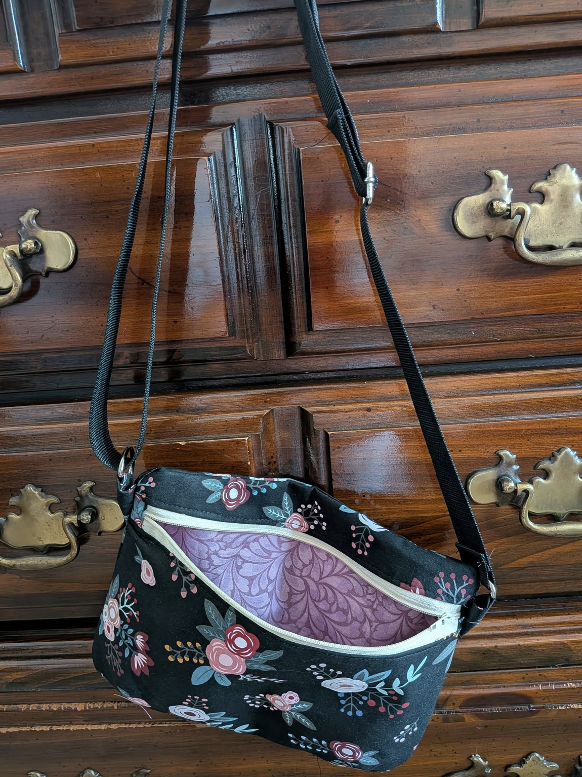 Reine Crossbody Bag hanging on dresser