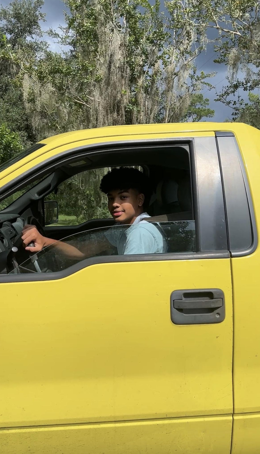 Teenager driving yellow truck